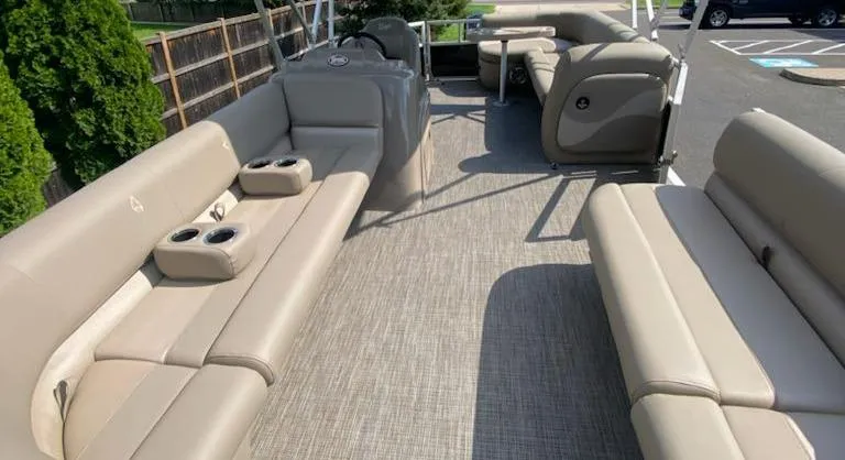 Slide: The Image of 2024 Ranger Reata 200C pontoon boat with spacious seating and cup holders. - 4