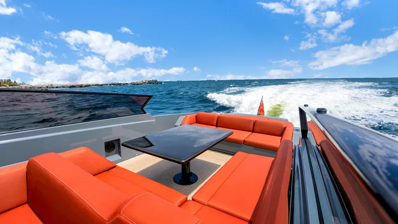 Slide: The Image of Luxurious 2017 Vanquish Yachts VQ 54 with orange seating, cruising on open water. - 12