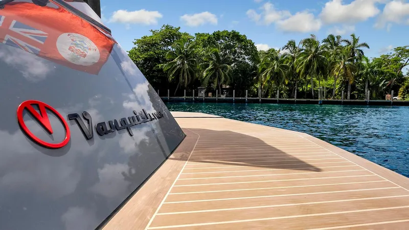 Slide: The Image of Vanquish Yachts VQ 54, 2017 model, docked by tropical waters with palm trees. - 24