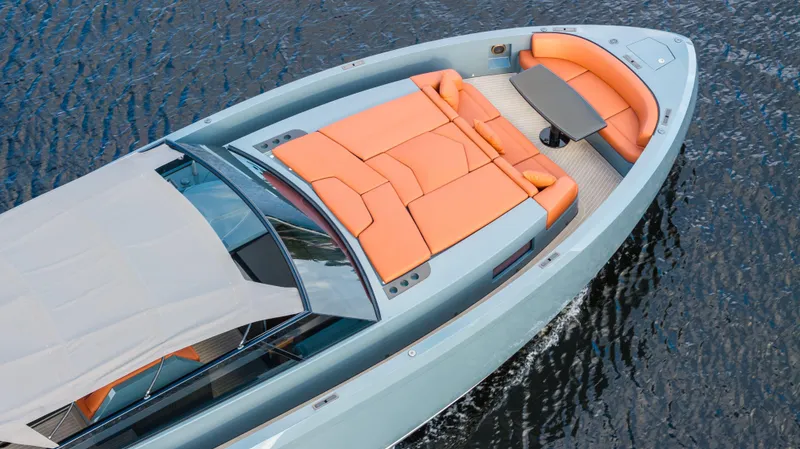 Slide: The Image of 2017 Vanquish Yachts VQ 54 with orange seating, cruising on water. - 26