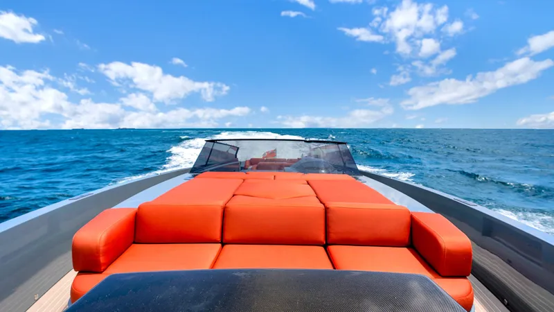 Slide: The Image of 2017 Vanquish Yachts VQ 54 with orange seating cruising on open sea under blue sky. - 6