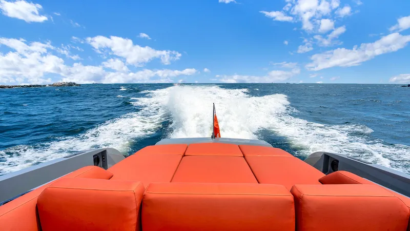 Slide: The Image of Vanquish Yachts VQ 54 (2017) cruising on open sea with vibrant orange seating. - 9