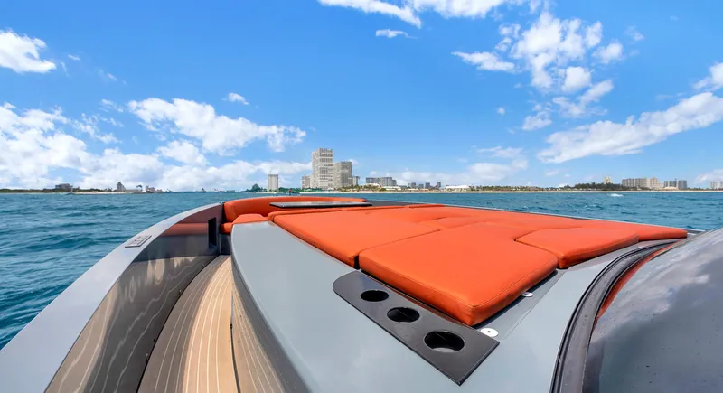 Slide: The Image of 2017 Vanquish Yachts VQ 54 on open water, featuring sleek design and vibrant orange seating. - 15