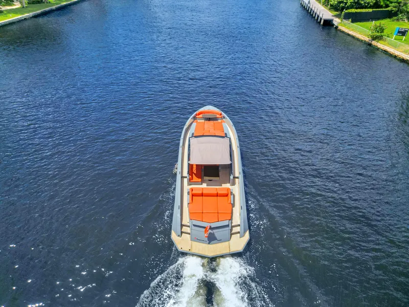 Slide: The Image of Aerial view of 2017 Vanquish Yachts VQ 54 cruising on a serene waterway. - 5
