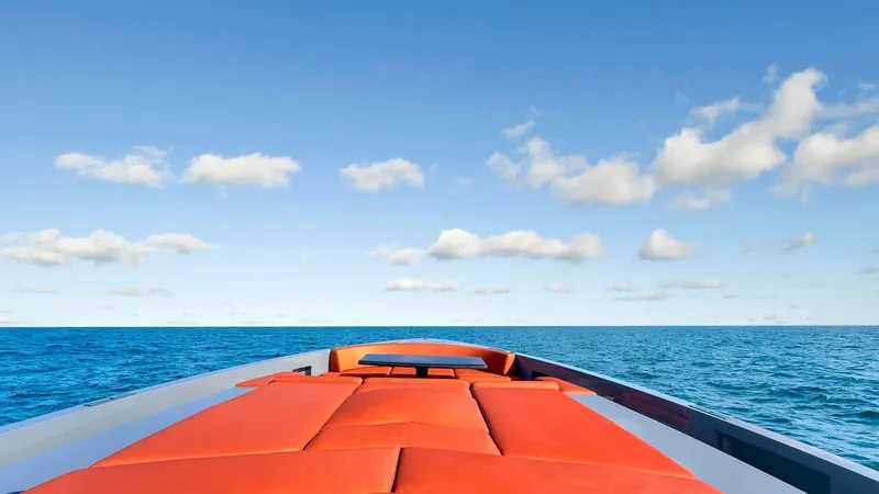 Slide: The Image of Vanquish Yachts VQ 54 (2017) with orange deck, cruising on open sea under blue sky. - 8