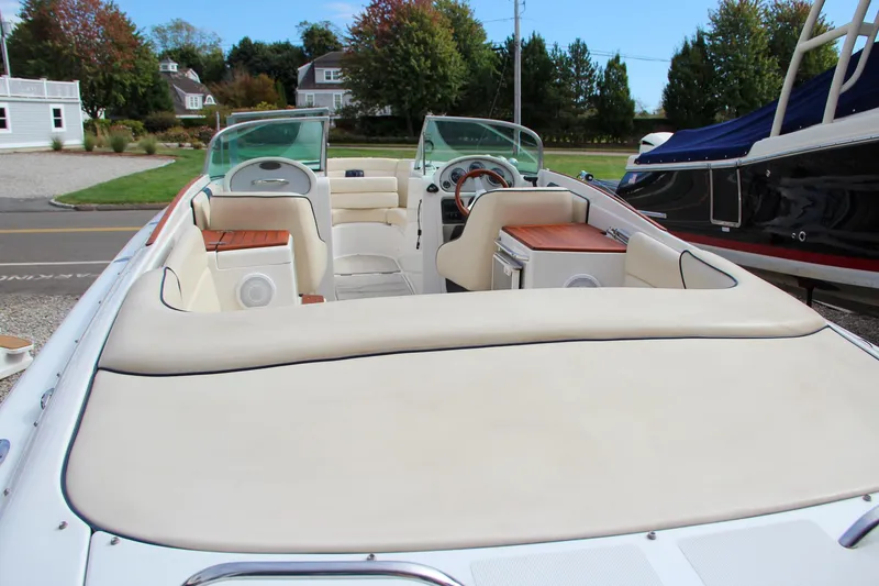 Slide: The Image of 2004 Chris-Craft Launch 25 boat interior with beige seating and wooden accents. - 10