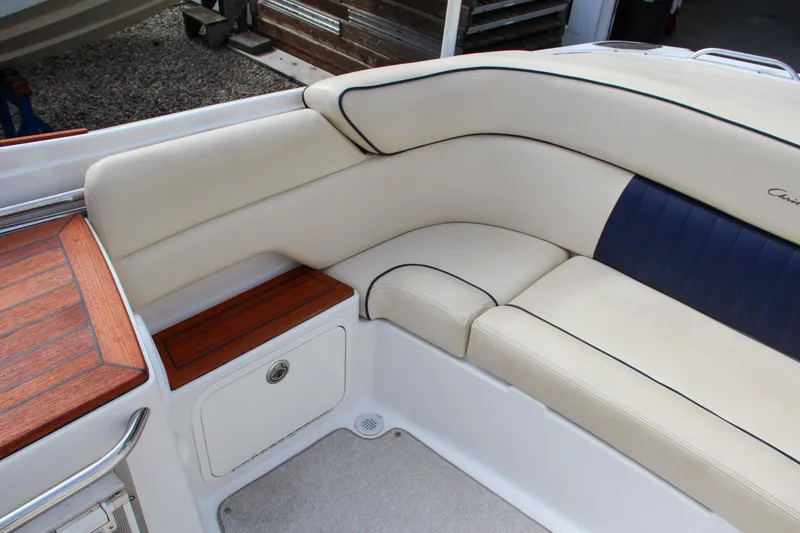 Slide: The Image of 2004 Chris-Craft Launch 25 boat interior with cream leather seating and wooden accents. - 11