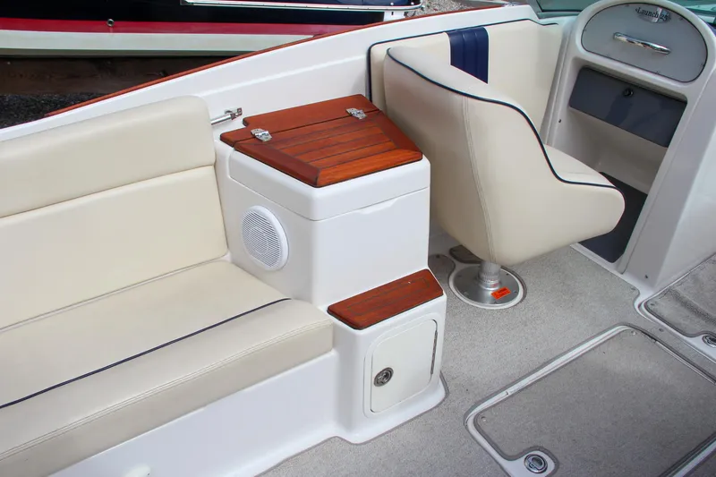 Slide: The Image of 2004 Chris-Craft Launch 25 interior with beige seating and wood accents. - 13