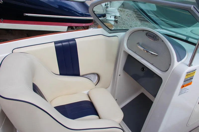 Slide: The Image of 2004 Chris-Craft Launch 25 boat interior with cream and navy seating. - 17