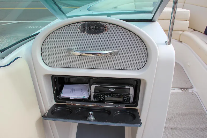 Slide: The Image of 2004 Chris-Craft Launch 25 boat dashboard with stereo and storage compartment. - 18