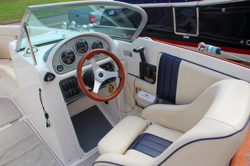 Slide: The Image of 2004 Chris-Craft Launch 25 boat interior with steering wheel and dashboard. - 19