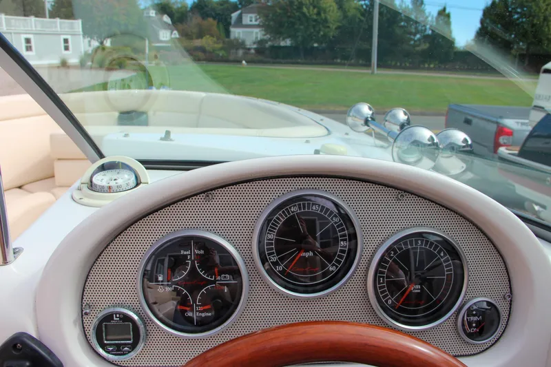 Slide: The Image of Dashboard of 2004 Chris-Craft Launch 25 boat with gauges and steering wheel. - 21