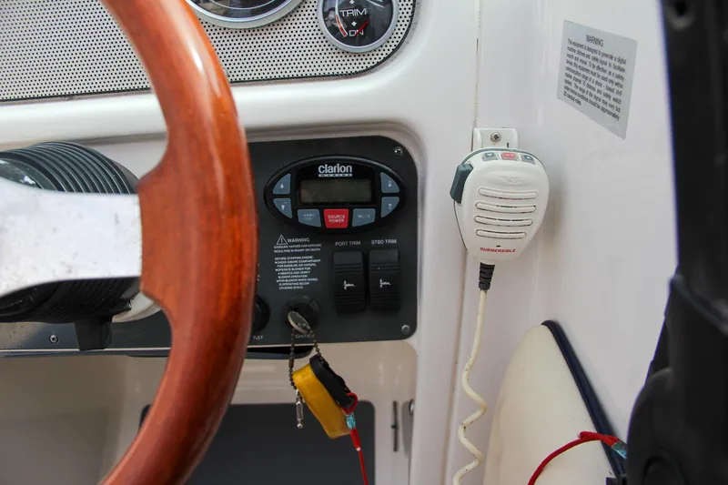 Slide: The Image of 2004 Chris-Craft Launch 25 dashboard with steering wheel and radio controls. - 22
