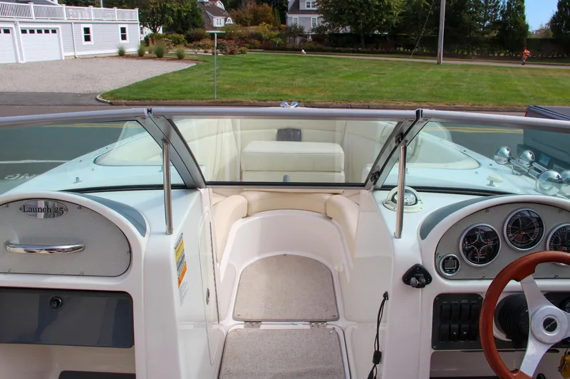 Slide: The Image of 2004 Chris-Craft Launch 25 boat interior with steering wheel and dashboard view. - 24