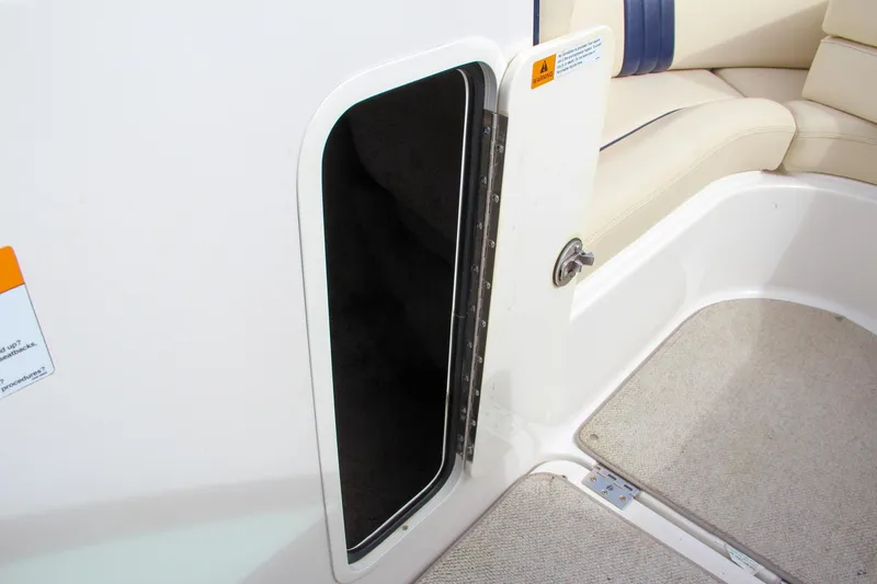 Slide: The Image of 2004 Chris-Craft Launch 25 boat interior with open storage compartment and seating area. - 26