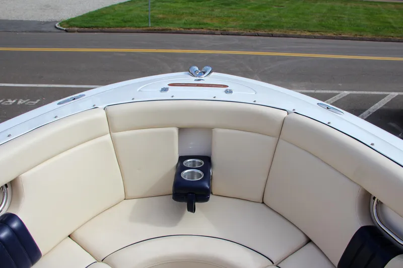 Slide: The Image of 2004 Chris-Craft Launch 25 boat interior with cream seating and cup holders. - 28