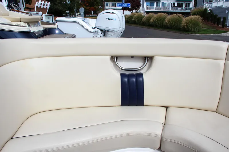 Slide: The Image of 2004 Chris-Craft Launch 25 boat interior with beige seating and blue accents. - 30