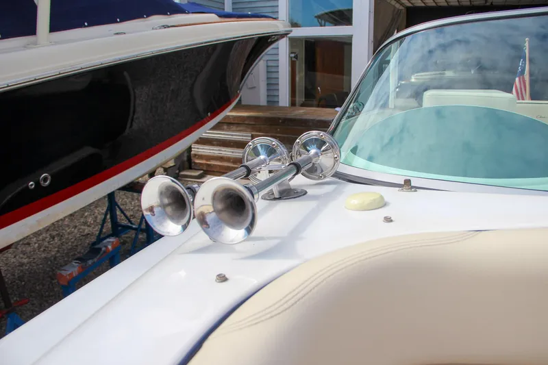 Slide: The Image of 2004 Chris-Craft Launch 25 boat with chrome horns and sleek design. - 31