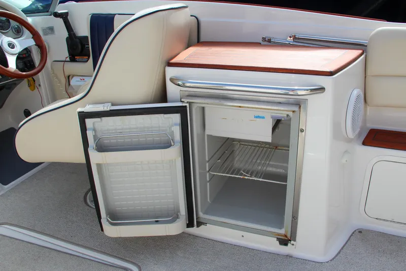 Slide: The Image of 2004 Chris-Craft Launch 25 boat interior with open mini fridge. - 34