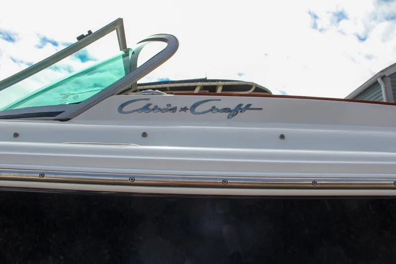 Slide: The Image of 2004 Chris-Craft Launch 25 boat side view with logo and windshield. - 39