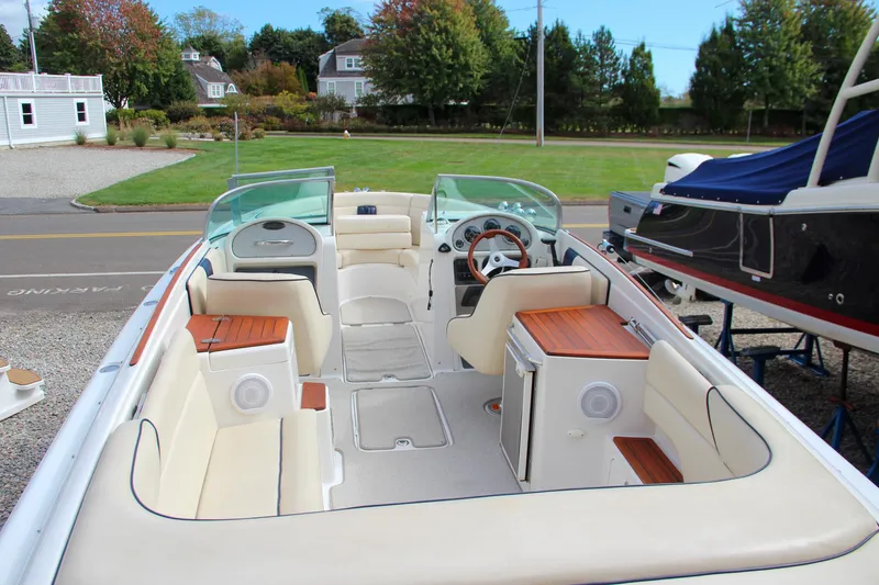 Slide: The Image of 2004 Chris-Craft Launch 25 boat interior with beige seating and wooden accents. - 4