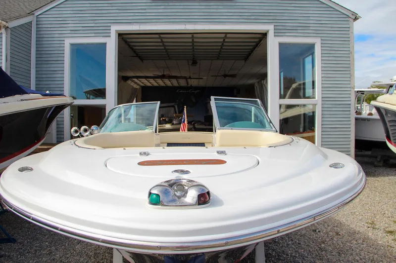 Slide: The Image of 2004 Chris-Craft Launch 25 boat in front of a boathouse. - 40