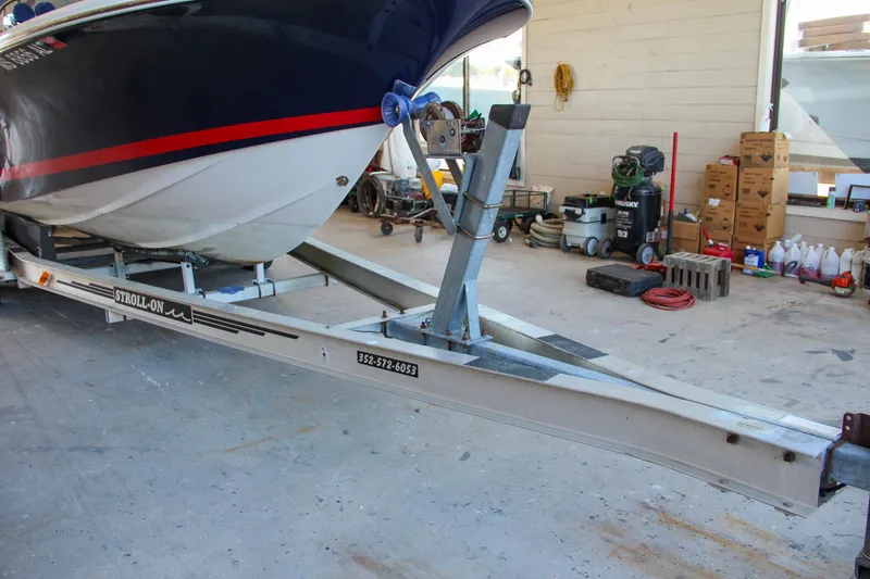 Slide: The Image of 2004 Chris-Craft Launch 25 boat on trailer in a garage setting. - 46