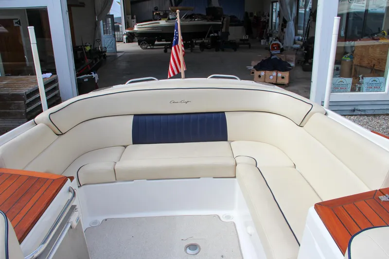 Slide: The Image of 2004 Chris-Craft Launch 25 boat interior with beige seating and wooden accents. - 5