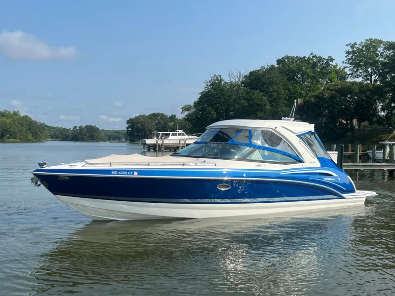 The Image of 2020 Formula 350 Crossover Bowrider in blue on a calm lake. - 0