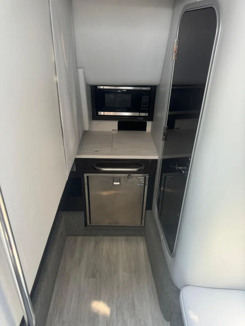 Slide: The Image of 2020 Formula 350 Crossover Bowrider interior with kitchenette and modern appliances. - 10