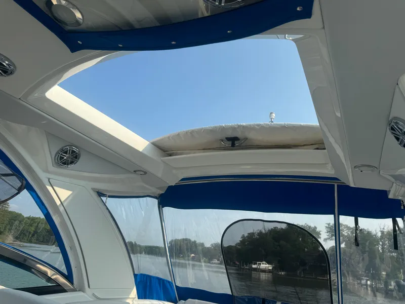 Slide: The Image of Interior view of 2020 Formula 350 Crossover Bowrider with open sunroof and blue accents. - 17