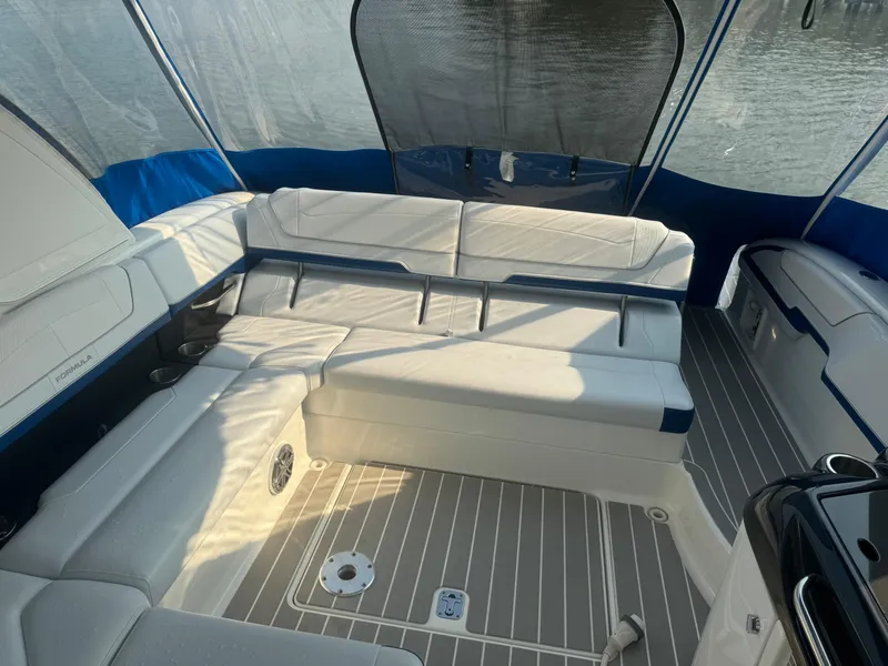 Slide: The Image of 2020 Formula 350 Crossover Bowrider interior with white seating and blue accents. - 18