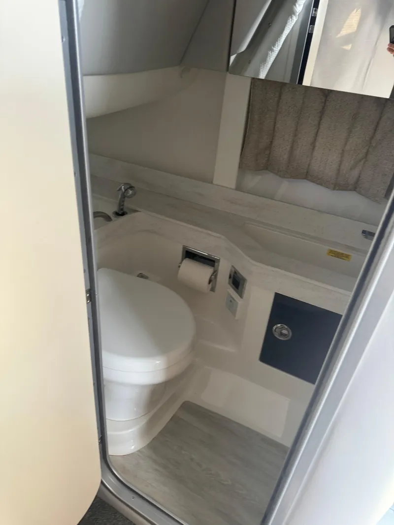 Slide: The Image of 2020 Formula 350 Crossover Bowrider bathroom interior with toilet and sink. - 8