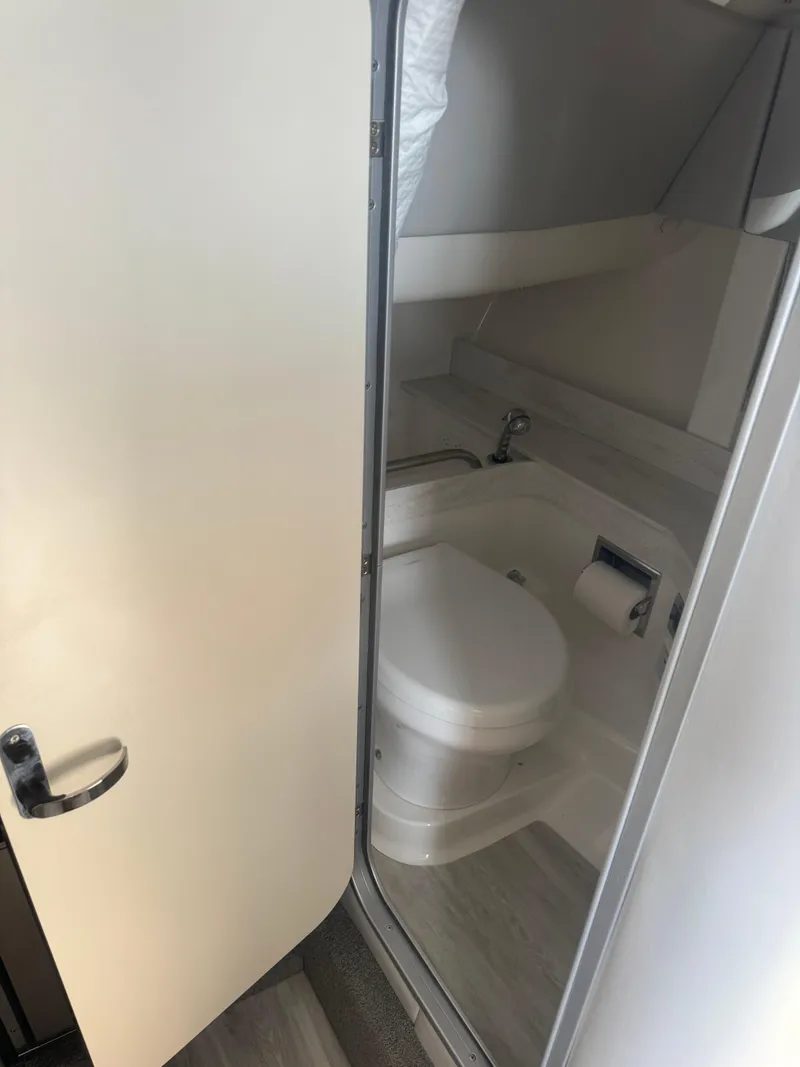 Slide: The Image of 2020 Formula 350 Crossover Bowrider bathroom interior with toilet and sink. - 9