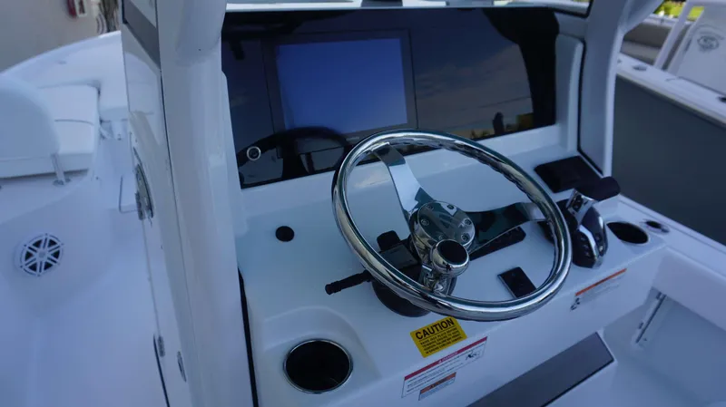 Slide: The Image of 2025 Sportsman 227 MASTERS boat helm with steering wheel and control panel. - 15