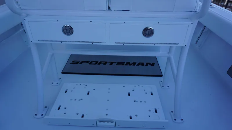 Slide: The Image of 2025 Sportsman 227 MASTERS boat interior with storage drawers and logo mat. - 19