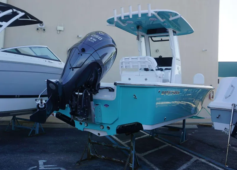 Slide: The Image of 2025 Sportsman 227 MASTERS boat with powerful outboard motor, displayed outdoors. - 2