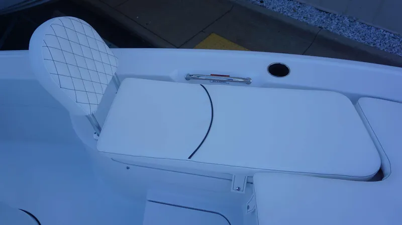 Slide: The Image of 2025 Sportsman 227 MASTERS boat seating with white cushioned bench and backrest. - 9