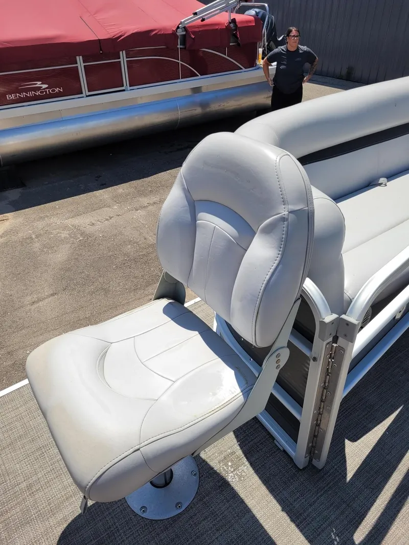 Slide: The Image of 2018 Sweetwater SW2286BF boat seat with gray upholstery on a sunny day. - 12