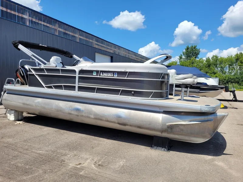 Slide: The Image of 2018 Sweetwater SW2286BF pontoon boat parked outdoors under a blue sky. - 2