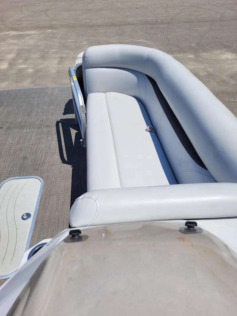 Slide: The Image of 2018 Sweetwater SW2286BF boat interior with white seating and gray flooring. - 8
