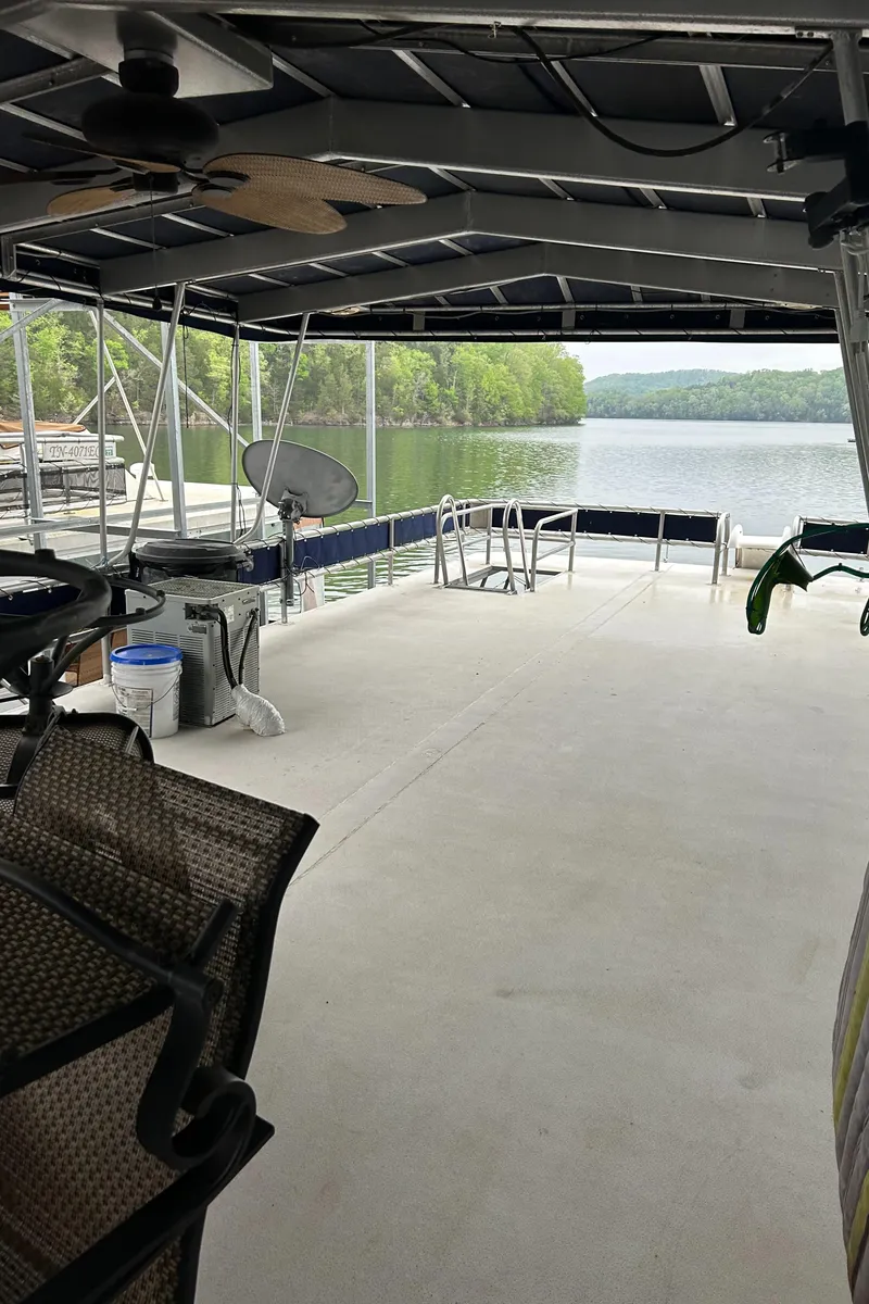 Slide: The Image of 1988 Waterhouse houseboat with catwalks, featuring spacious deck and scenic lake view. - 10