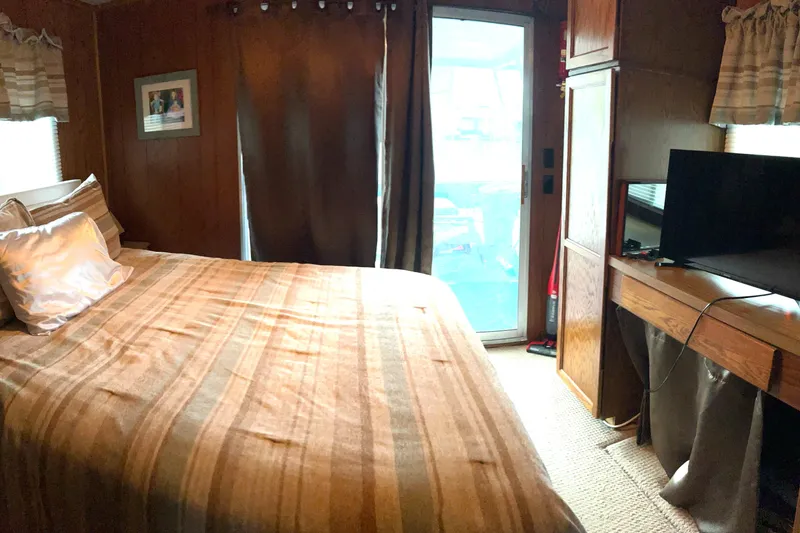 Slide: The Image of Cozy bedroom in 1988 Waterhouse houseboat with catwalks, featuring a bed, TV, and natural light. - 12