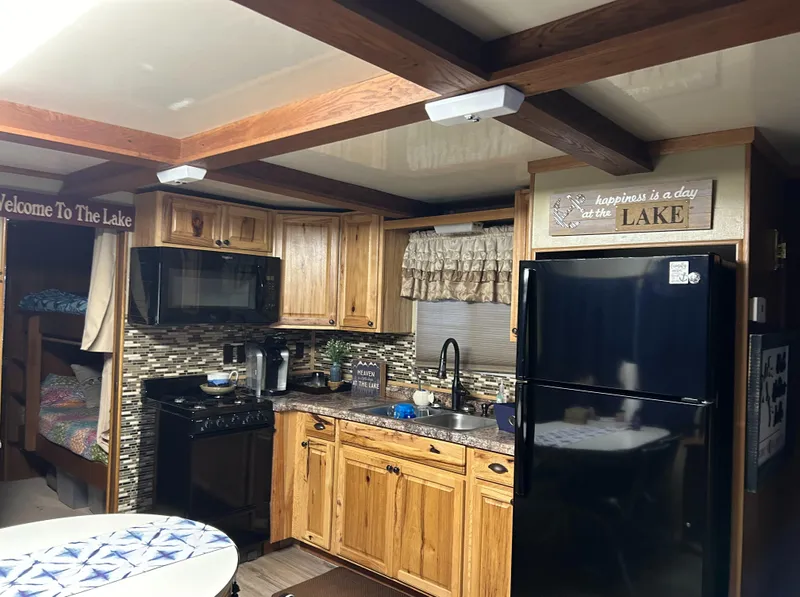 Slide: The Image of Cozy kitchen in 1988 Waterhouse houseboat with wooden cabinets and modern appliances. - 3
