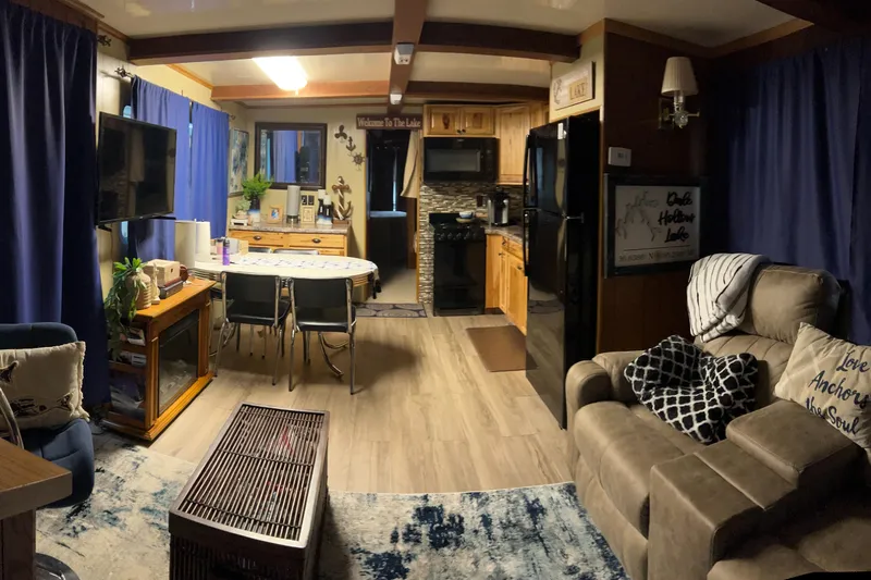 Slide: The Image of Cozy 1988 Waterhouse houseboat interior with modern kitchen, dining area, and comfortable seating. - 5