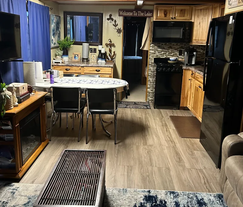 Slide: The Image of Interior of a 1988 Waterhouse houseboat with cozy kitchen and dining area. - 6
