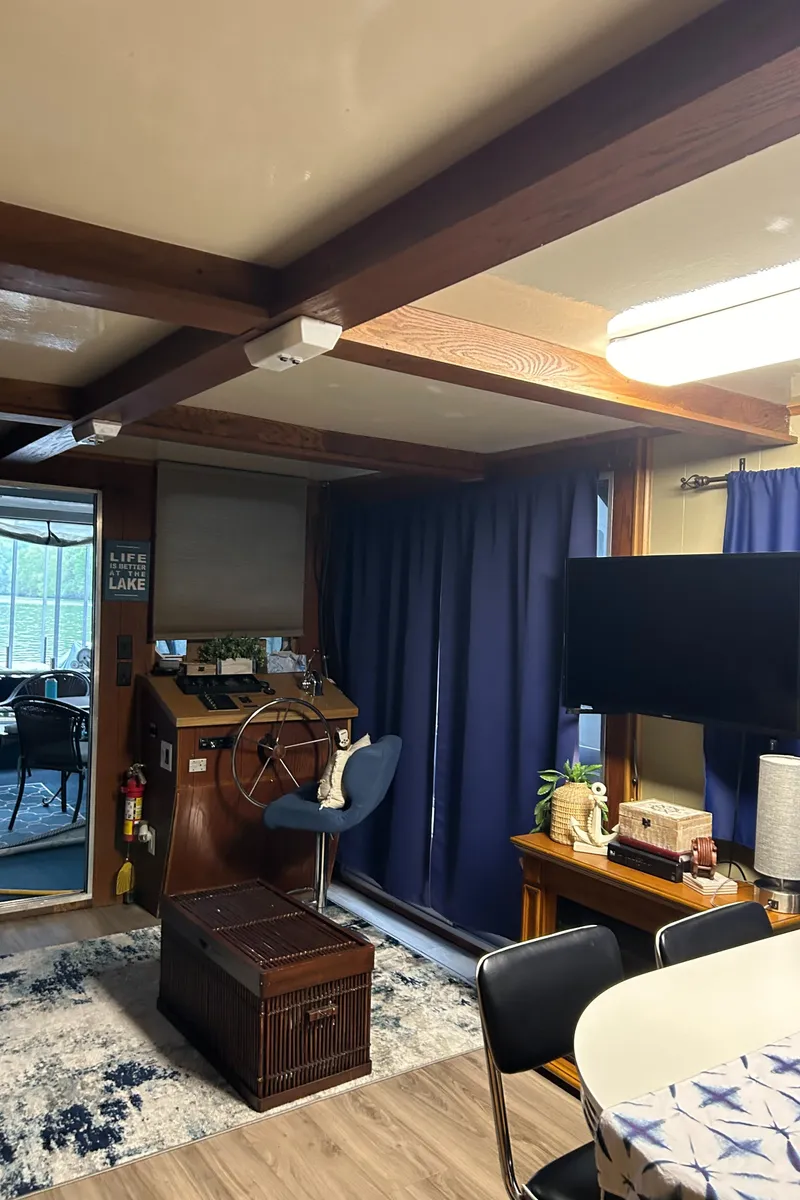 Slide: The Image of Interior of a 1988 Waterhouse houseboat with catwalks, featuring a cozy living area. - 7