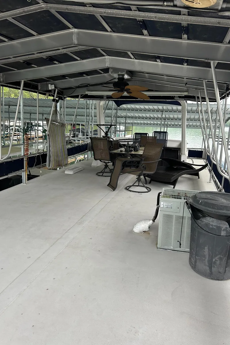 Slide: The Image of 1988 Waterhouse houseboat with catwalks, featuring outdoor seating and covered deck area. - 8