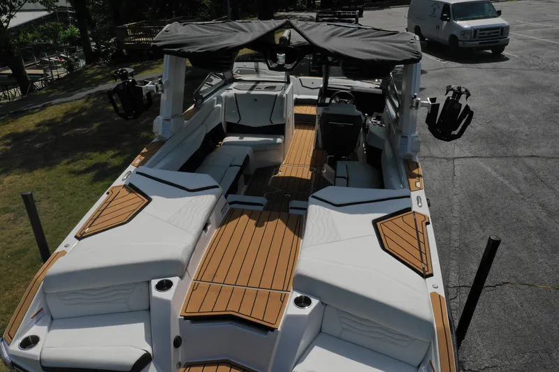 Slide: The Image of 2025 Nautique G23 boat with sleek interior and wooden deck accents. - 11