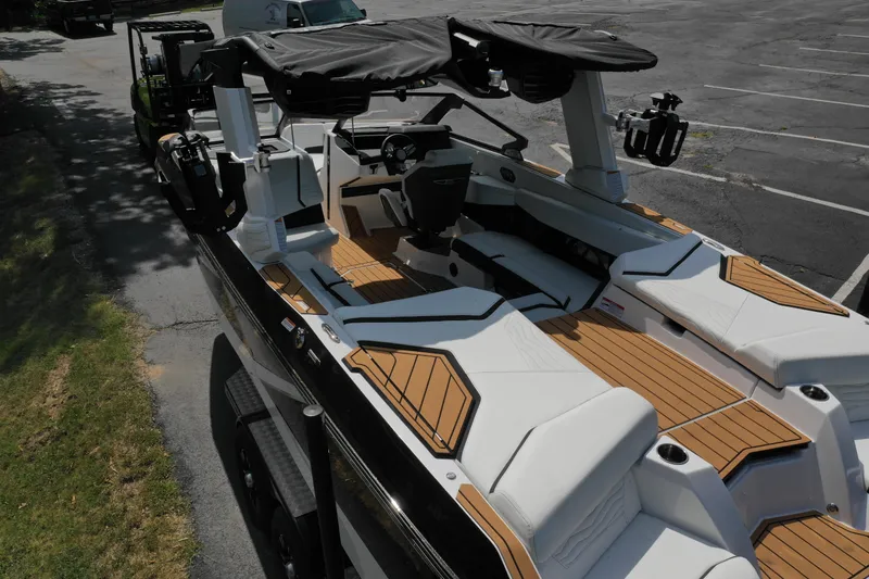 Slide: The Image of 2025 Nautique G23 boat with sleek design and spacious interior on a trailer. - 15
